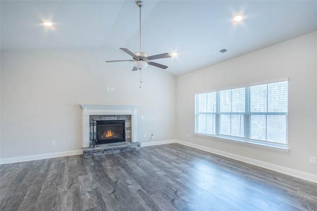 unfurnished living room featuring dark wood-type flooring, ceiling fan, a fireplace, and vaulted ceiling