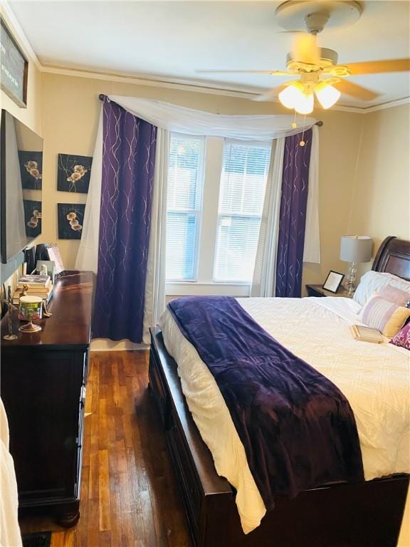 bedroom featuring crown molding, ceiling fan, and dark wood-type flooring