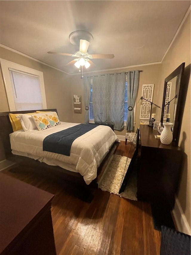 bedroom featuring ornamental molding, ceiling fan, and dark hardwood / wood-style flooring