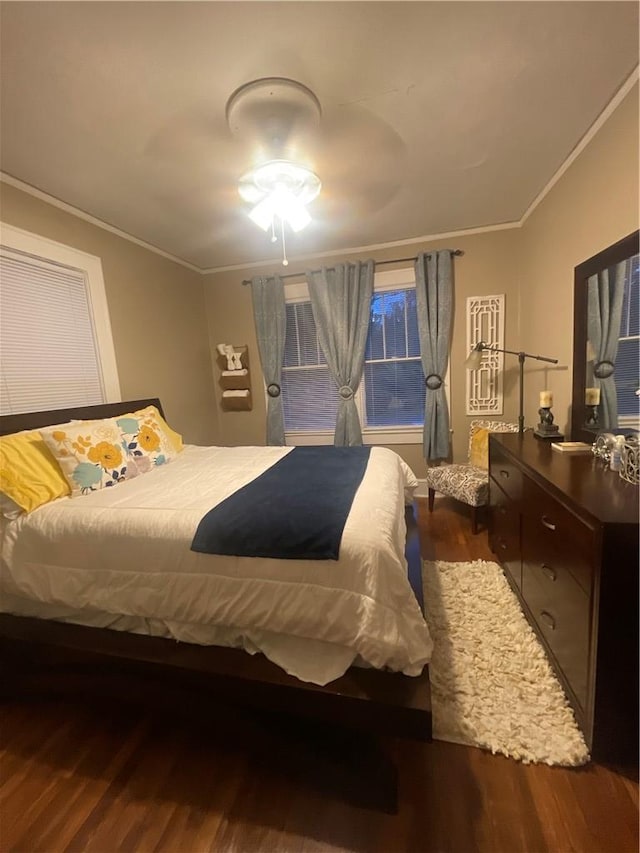 bedroom with ornamental molding and dark hardwood / wood-style flooring