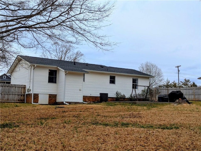 back of property featuring a yard and central air condition unit