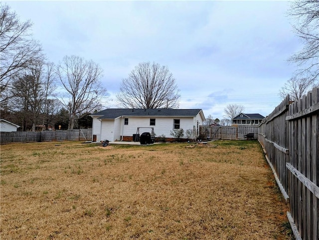 rear view of house featuring a lawn