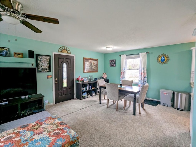 dining space with light carpet and ceiling fan