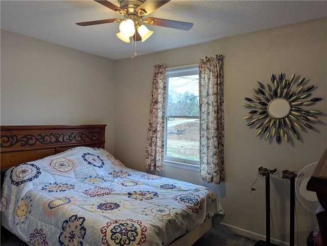 carpeted bedroom featuring multiple windows, ceiling fan, and a textured ceiling