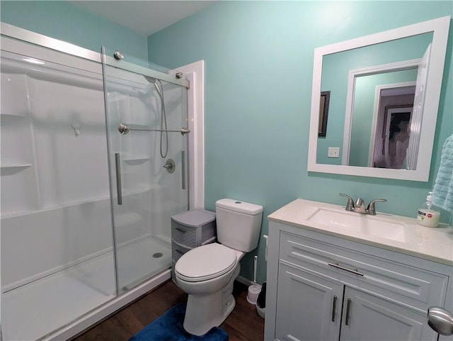 bathroom with vanity, hardwood / wood-style floors, toilet, and walk in shower