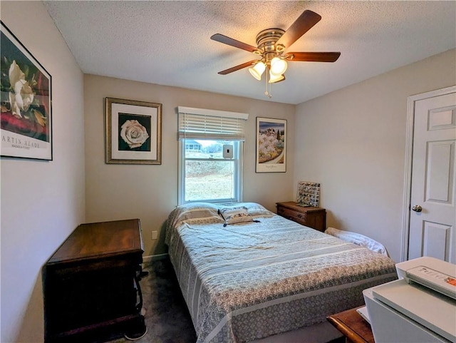 carpeted bedroom with ceiling fan and a textured ceiling