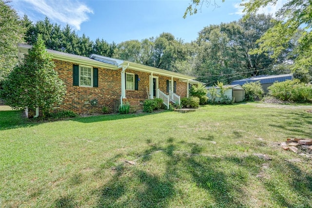 single story home with a storage unit and a front lawn