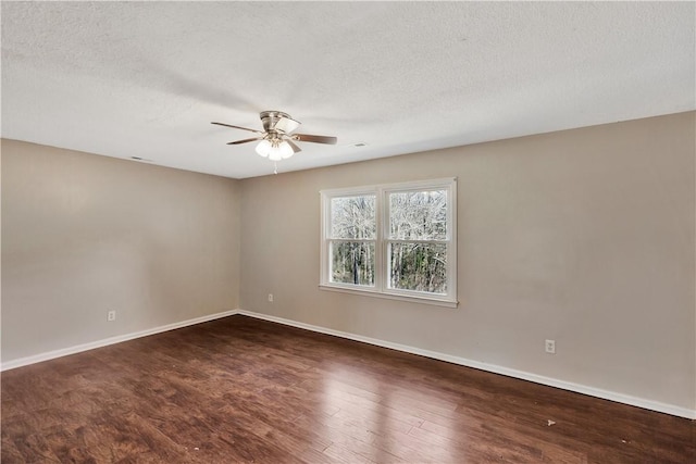 empty room featuring dark hardwood / wood-style flooring, a textured ceiling, and ceiling fan