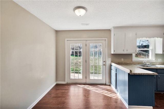 entryway featuring dark hardwood / wood-style floors and a textured ceiling