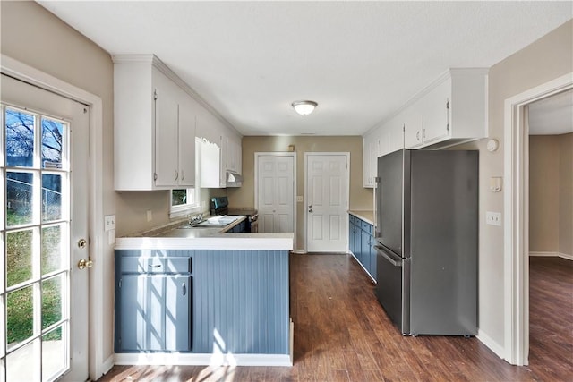 kitchen with range with electric cooktop, dark hardwood / wood-style floors, white cabinets, and stainless steel refrigerator