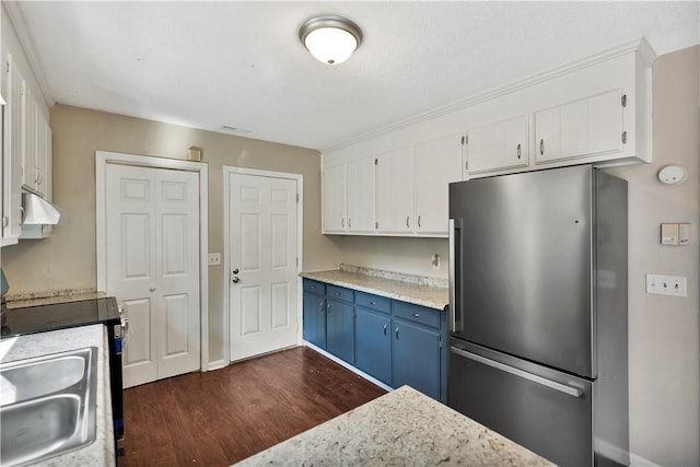 kitchen with sink, blue cabinetry, appliances with stainless steel finishes, white cabinetry, and dark hardwood / wood-style floors