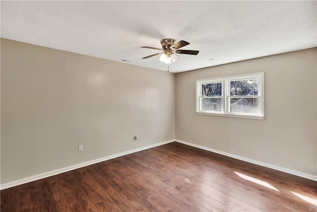 spare room with ceiling fan, dark hardwood / wood-style floors, and a textured ceiling