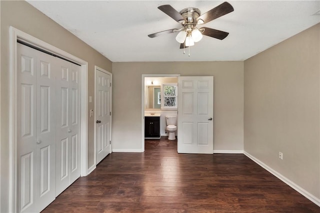 unfurnished bedroom with dark hardwood / wood-style flooring, a closet, ceiling fan, and ensuite bathroom