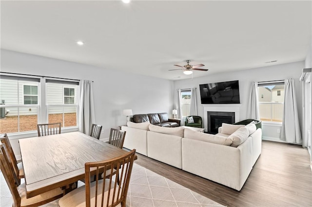 living room with ceiling fan and light wood-type flooring