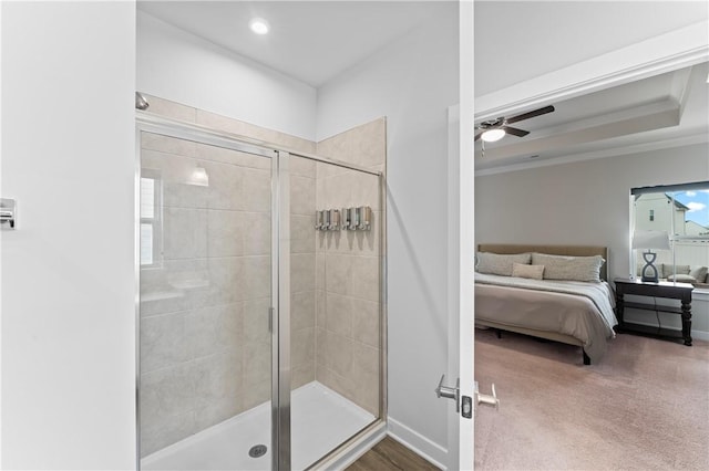 bathroom with ornamental molding, ceiling fan, and a shower with shower door