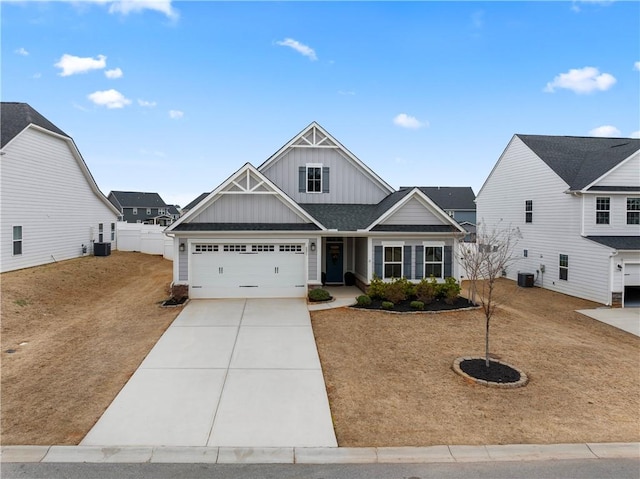 view of front of home with central AC, a garage, and a front yard