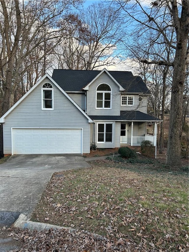 front of property featuring covered porch and a garage