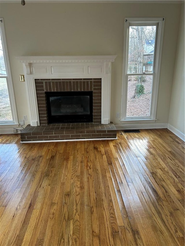 details with wood-type flooring and a brick fireplace