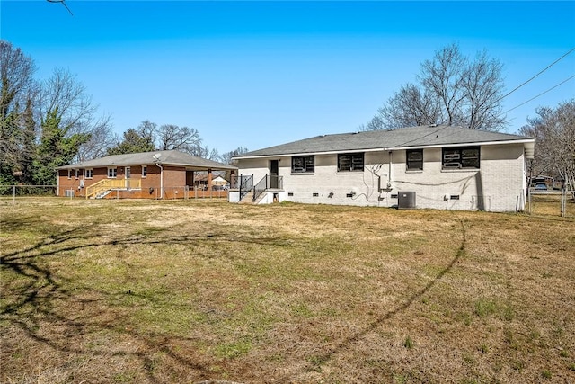 back of property with crawl space, central AC, a yard, and fence