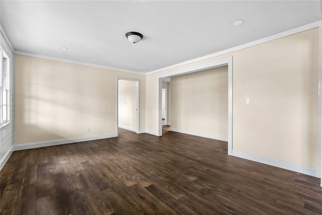 unfurnished bedroom with ornamental molding, dark wood finished floors, and baseboards