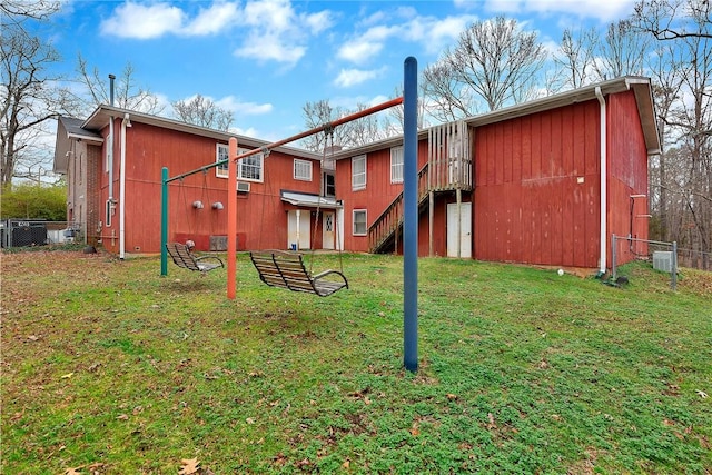 rear view of property featuring a yard