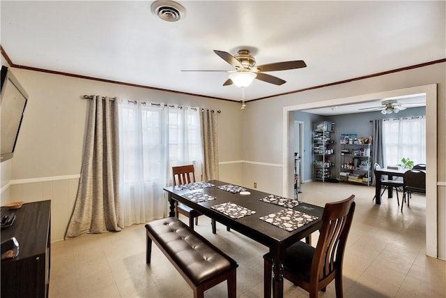 dining room featuring ornamental molding and ceiling fan