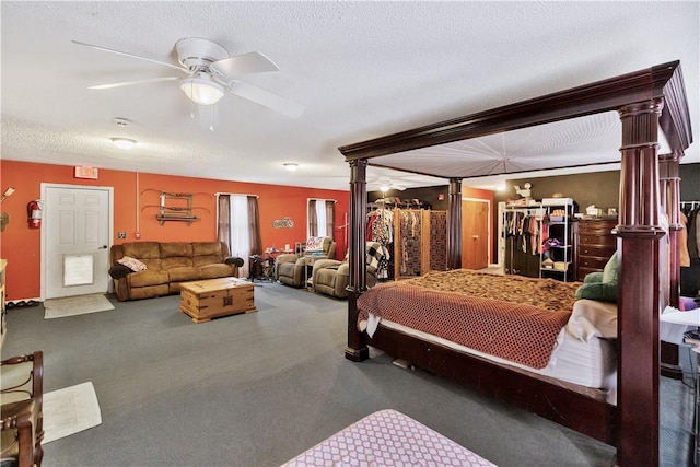 bedroom featuring decorative columns, ceiling fan, and a textured ceiling