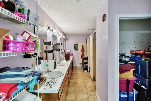 bathroom with sink and a textured ceiling