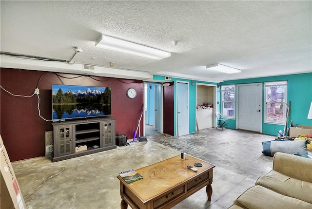 living room featuring concrete floors and a textured ceiling