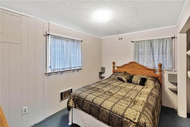 carpeted bedroom featuring crown molding and a textured ceiling