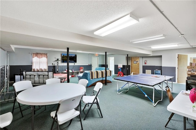 recreation room featuring carpet flooring and a textured ceiling