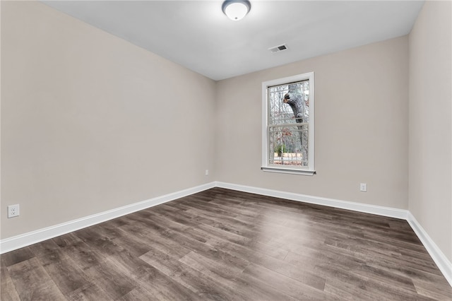 empty room featuring dark wood-type flooring