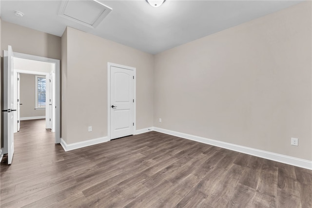 empty room with dark hardwood / wood-style flooring