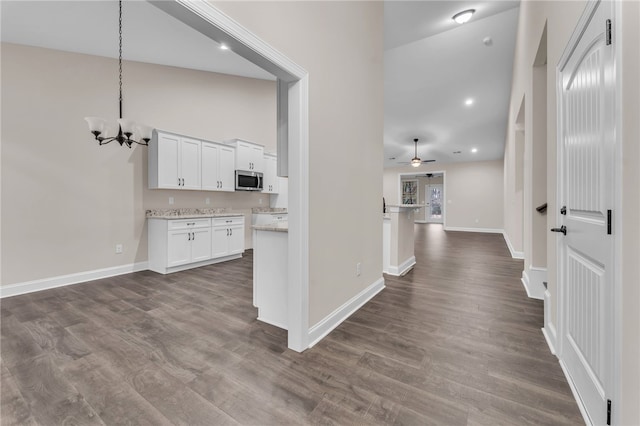 hallway featuring a notable chandelier and dark hardwood / wood-style floors