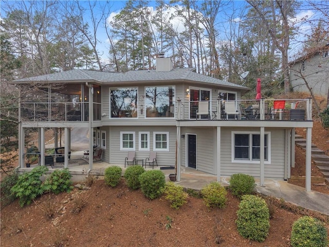 back of house with a sunroom and a patio area