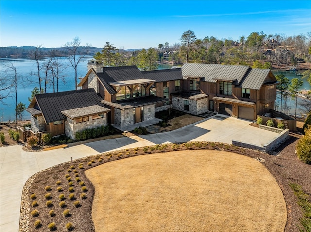 view of front of home with a garage and a water view