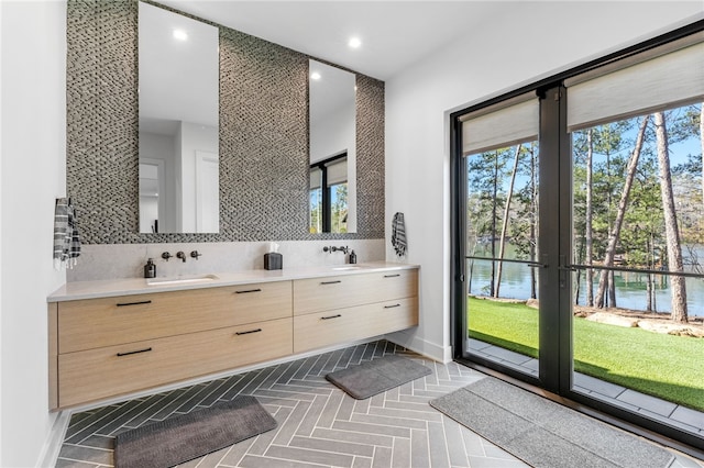 bathroom with tasteful backsplash, vanity, and a water view