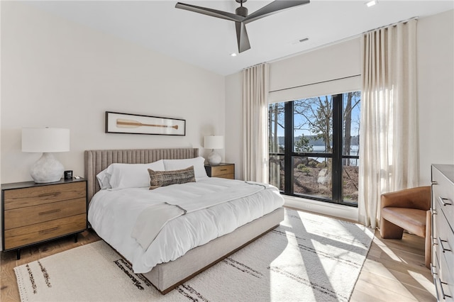 bedroom with light hardwood / wood-style flooring and ceiling fan