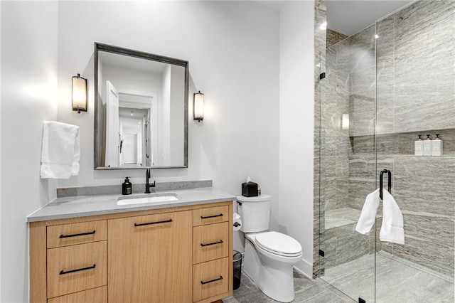 bathroom featuring vanity, an enclosed shower, and toilet