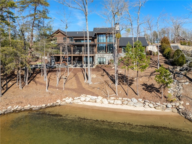 rear view of house featuring a water view