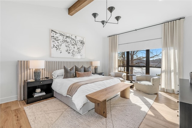 bedroom with an inviting chandelier, vaulted ceiling with beams, and light hardwood / wood-style floors