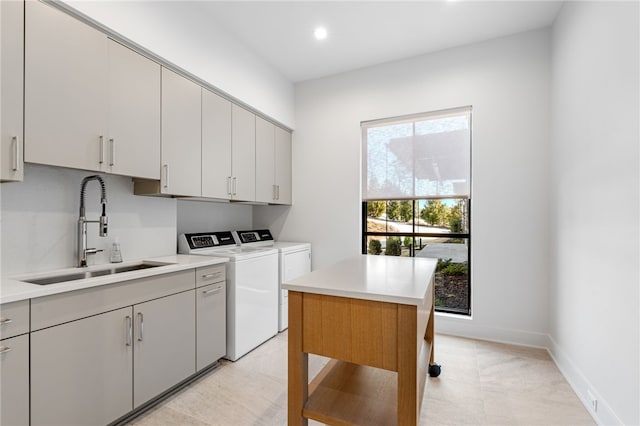 laundry area with cabinets, sink, and washing machine and clothes dryer