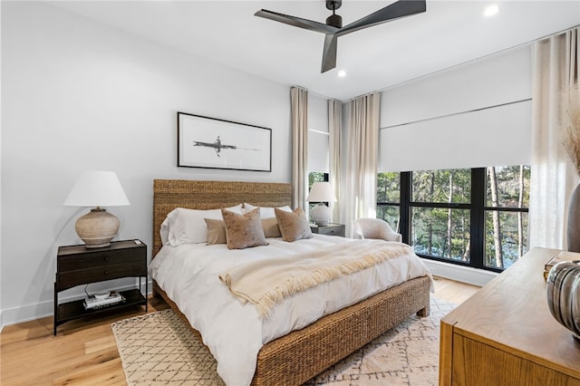 bedroom with light hardwood / wood-style flooring and ceiling fan