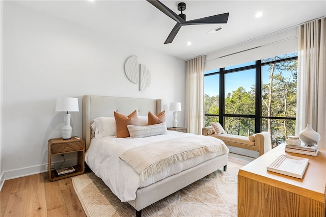 bedroom with ceiling fan and light wood-type flooring