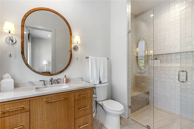 bathroom with tile patterned flooring, vanity, an enclosed shower, and toilet