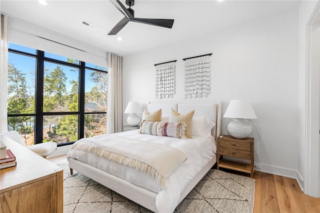 bedroom with ceiling fan and light hardwood / wood-style floors