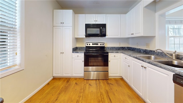 kitchen with sink, stainless steel appliances, light hardwood / wood-style floors, and white cabinets