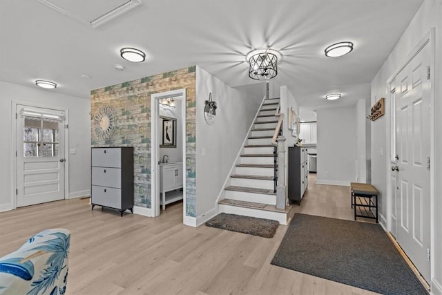 entrance foyer with sink and light hardwood / wood-style floors