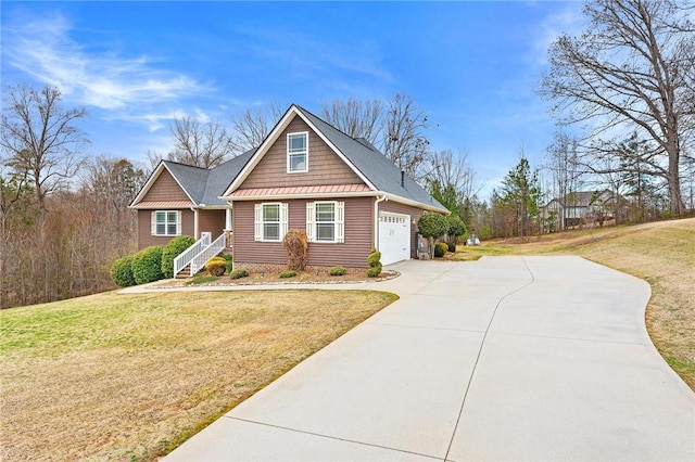 view of front of house with a garage and a front lawn