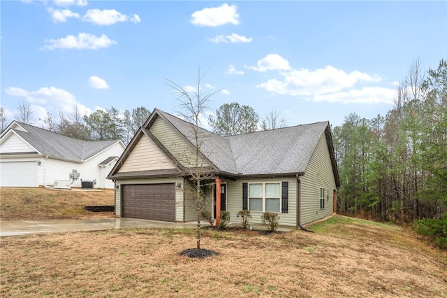 view of front of property with a garage, cooling unit, and a front lawn